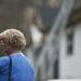 A woman shows emotion and walks by the burned house. Daniel Brenner I AnnArbor.com